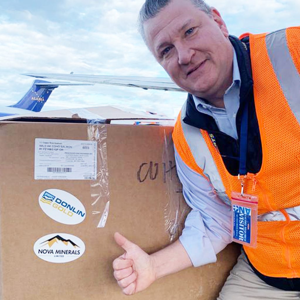 Photo of Nova CEO, Christopher Gerteisen with supply of Wild AK Coho Salmon for communities in need.