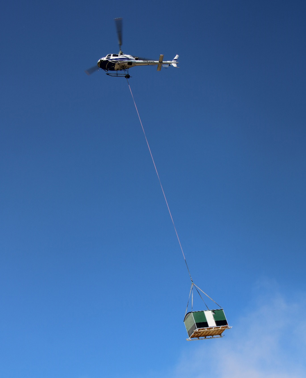 Photo of a helicopter flying safety huts to RPM